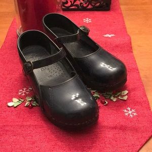Sanita brand Mary Jane patent leather clogs.